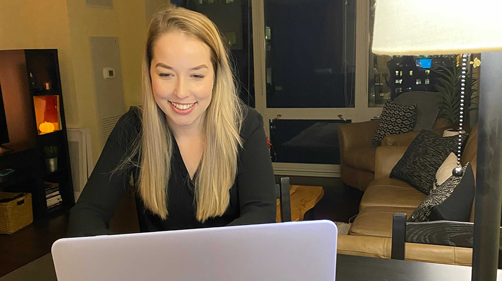Salesforce student group leader Kamille von der Linden smiling at her laptop.